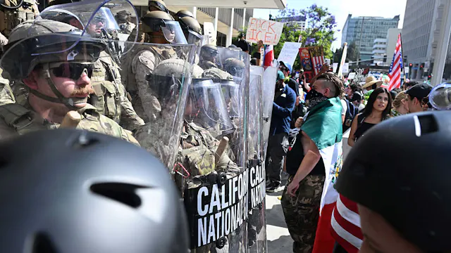 Los Angeles, CA - June 14: California National Guard and the U.S. Marines stand guard as protesters gather in front of the Edward R. Roybal Federal Building during the 'No Kings' protests Day in Los Angeles on Saturday, June 14, 2025.